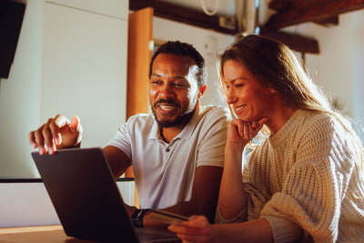 Guide to investing image of a couple looking at a laptop