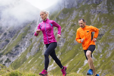Pensions image of couple running up a mountain