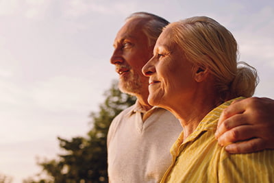 Post retirement, retired couple looking at sunset