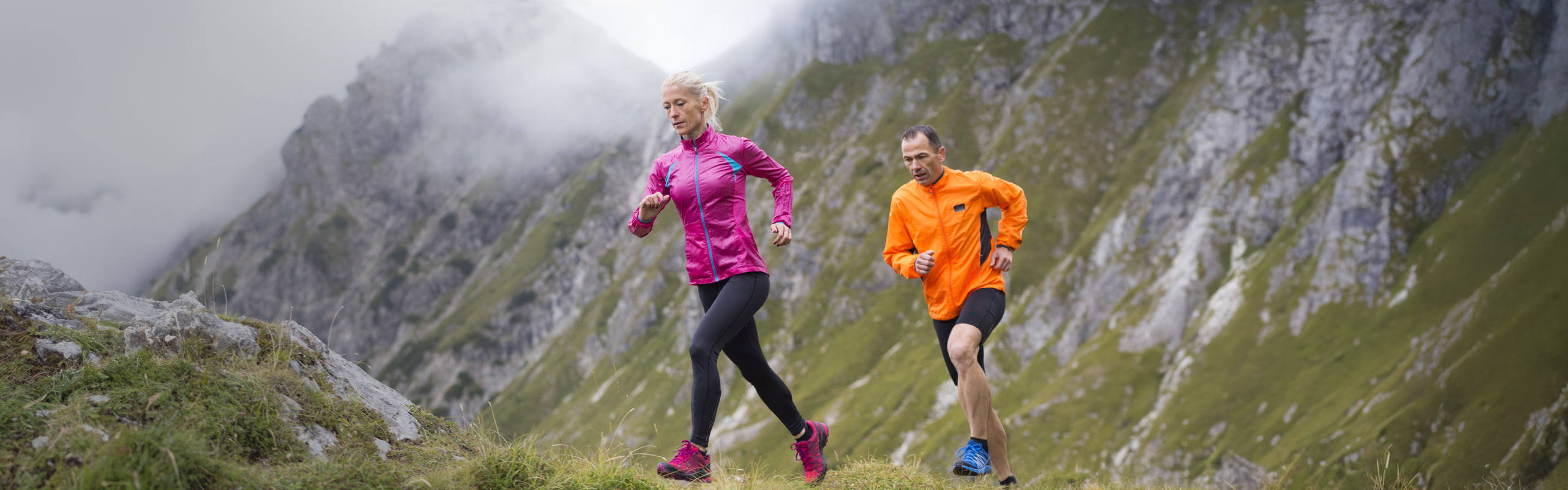 Retirement planning image of a a couple running up a mountain