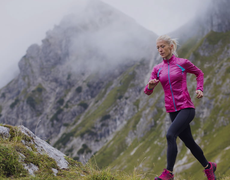 Retirement planning image of a a couple running up a mountain