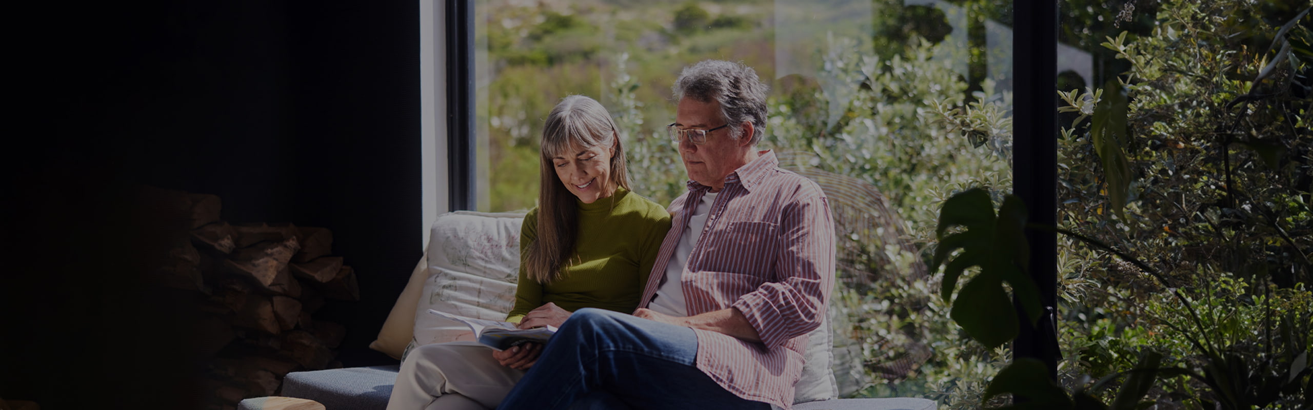 Wealth management image of happy couple reading a book