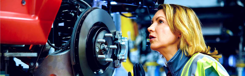 A mechanic inspecting a car