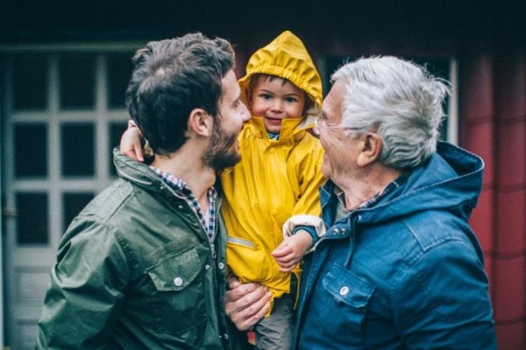 Financial planning, grandfather, father and son smiling and hugging